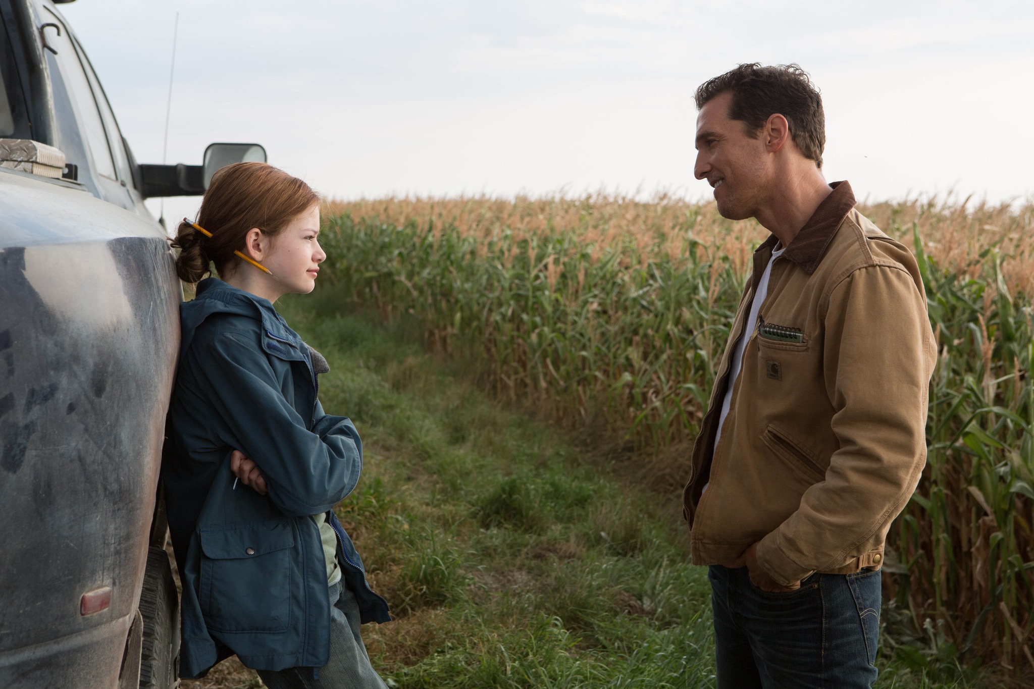 Matthew McConaughey as Cooper and Mackenzie Foy as Murphy share an emotional father-daughter moment by a truck in a cornfield from Interstellar (2014)