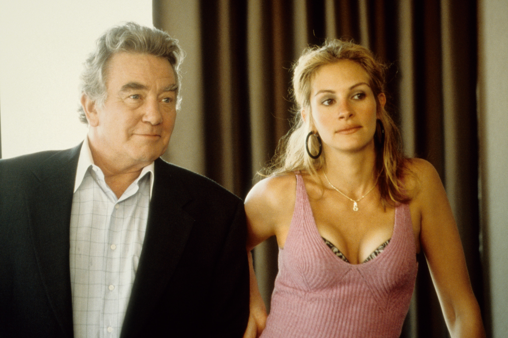 Julia Roberts as Erin Brockovich stands beside Albert Finney as Ed Masry