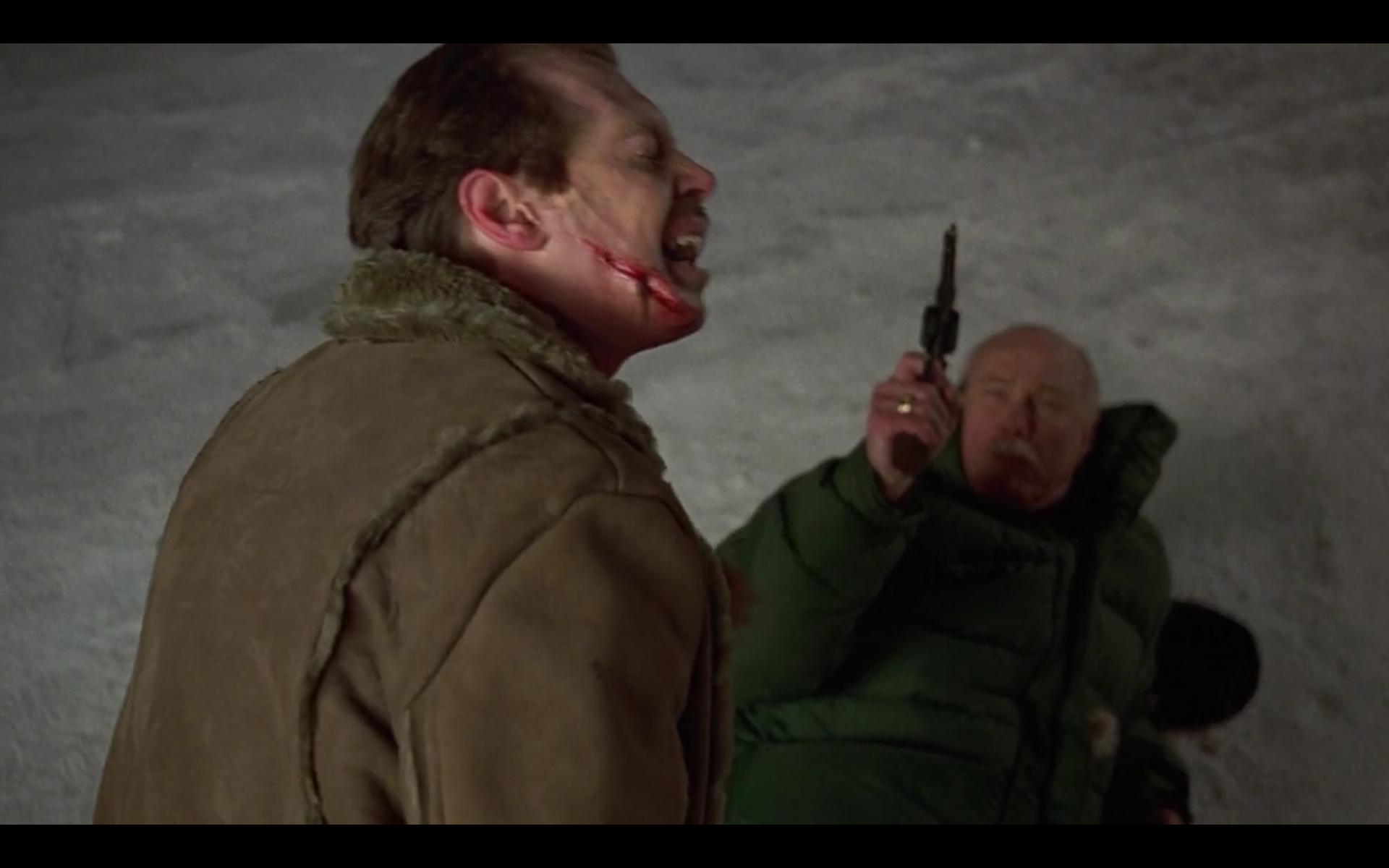 Steve Buscemi as Carl Showalter wounded and bleeding in the snow, as Wade Gustafson (Harve Presnell) pulls a gun in a deadly confrontation over a ransom deal gone wrong.