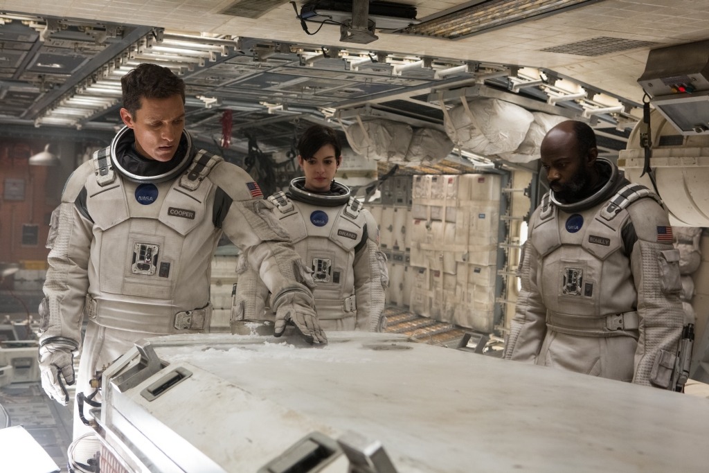 Matthew McConaughey, Anne Hathaway, and David Gyasi as NASA astronauts, investigating an icy surface aboard their spacecraft during a mission to find a habitable planet