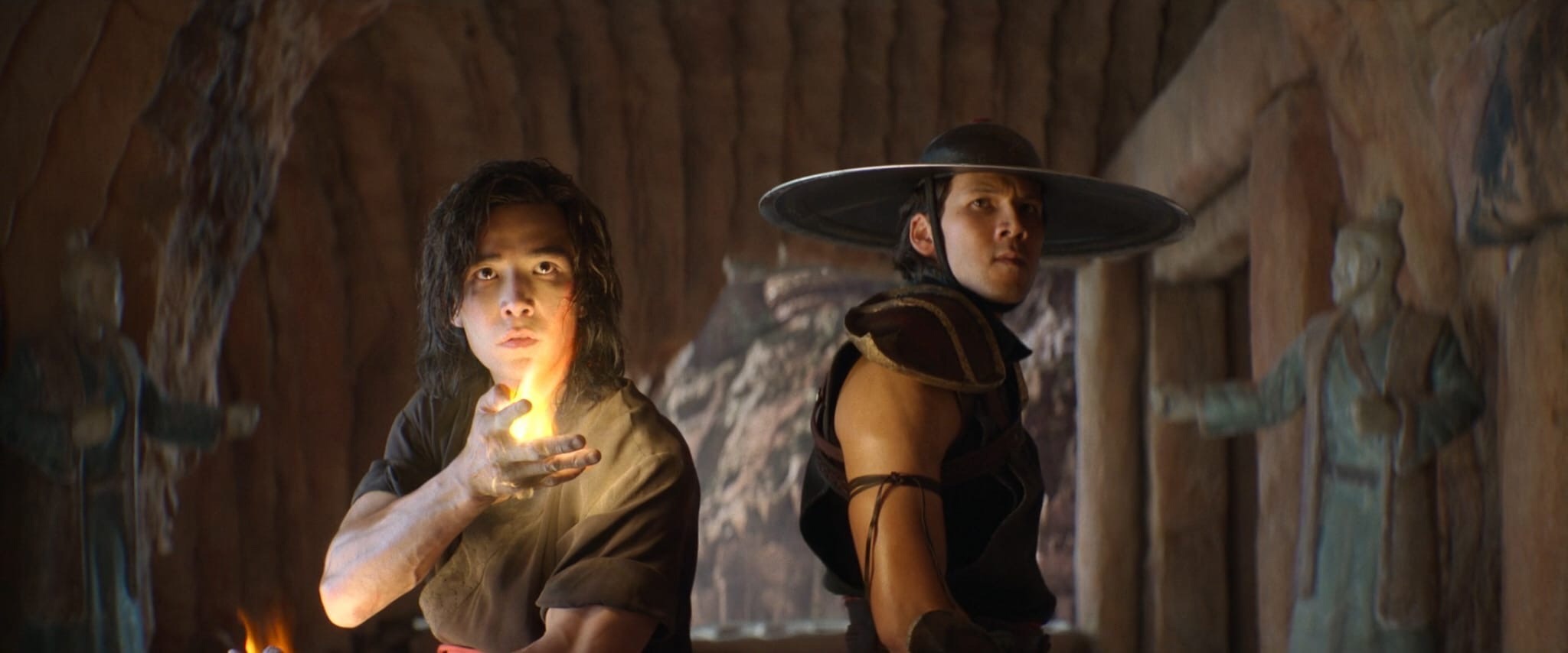 Liu Kang and Kung Lao inside Raiden’s temple, with Liu Kang summoning fire in his palm and Kung Lao standing ready with his iconic razor-sharp hat