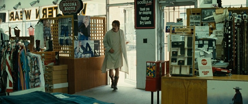 Llewelyn Moss, played by Josh Brolin, entering a Western clothing store to buy new boots after escaping a violent encounter.